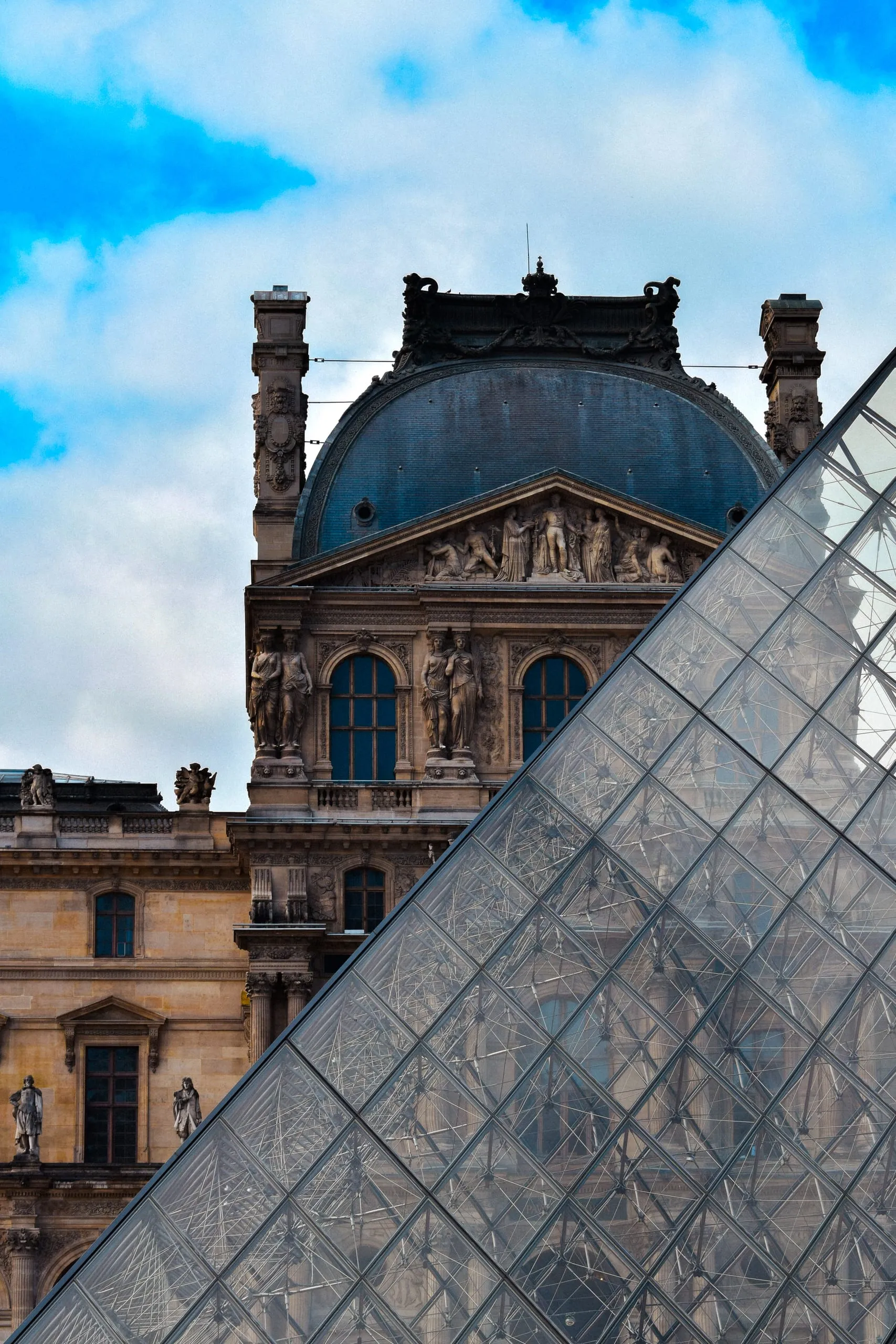 Louvre triangle in the foreground and the palace behind